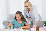 Mother helping her daughter during her homework