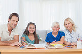 Smiling parents helping their children with their homework
