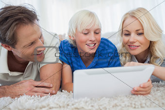Son and his parents using a tablet