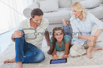 Young girl and her parents using a tablet