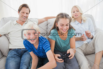Children playing video games on the couch