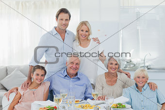 Extended family smiling at the dinner table