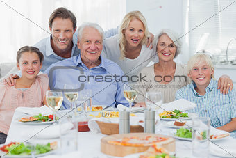 Extended family smiling at dinner family
