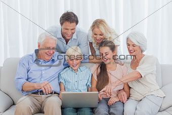 Extended family sitting on sofa