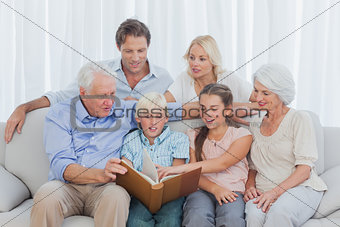 Extended family looking at a photo album