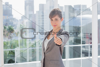 Businesswoman giving thumb up