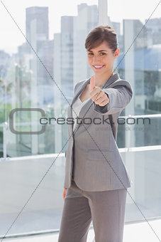 Succesful businesswoman giving thumb up