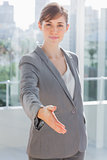Businesswoman with hand out for handshake