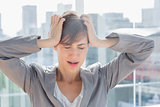 Frustrated businesswoman with hands on head