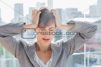 Frustrated businesswoman with hands on head
