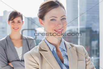 Happy businesswomen with arms crossed
