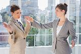 Annoyed businesswoman pointing at her rival
