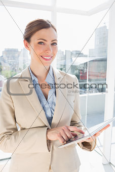Happy businesswoman using her tablet pc
