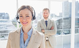 Call centre agent standing with colleague behind her