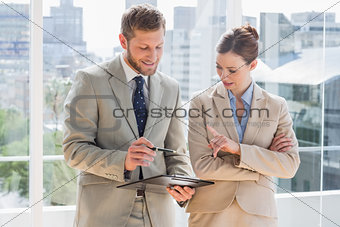 Business team going over document on clipboard