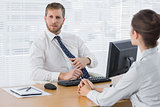 Businessman meeting with a colleague at his desk
