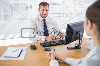 Businessman smiling at camera in his office
