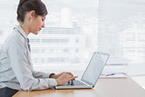 Businesswoman working on her laptop at desk