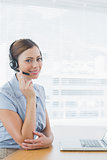 Call centre operator wearing headset at her desk