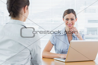 Businesswoman smiling at camera during an interview