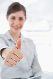 Young businesswoman giving thumb up