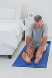 Mature man working out on mat