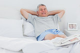 Retired man relaxing in bed