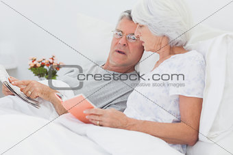 Mature couple looking at a newspaper