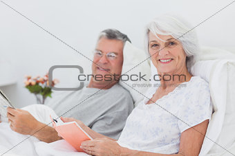 Portrait of a couple reading together in bed