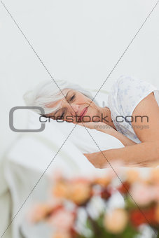 Peaceful woman sleeping in bed