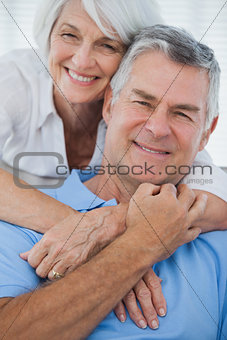 Portrait of woman embracing husband