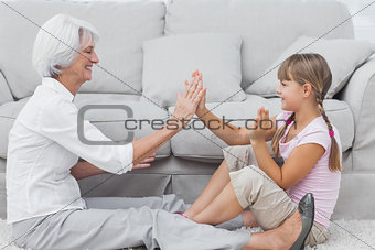 Young girl and grandmother playing together