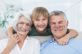 Grandson embracing his grandparents