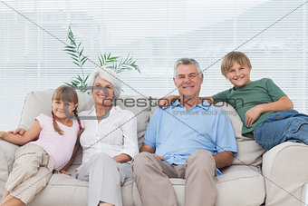 Grandparents and grandchildren sitting on couch