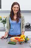 Attractive woman standing in her kitchen