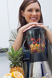 Attractive woman leaning on her blender