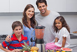 Family posing with a blender
