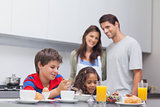 Children having breakfast in kitchen