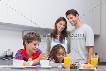 Children having breakfast in kitchen