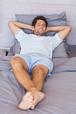Attractive man lying in bed