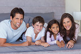 Cheerful family lying on bed