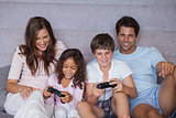 Smiling family playing video games