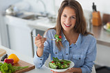 Pretty woman eating a salad