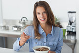 Attractive woman eating cereal
