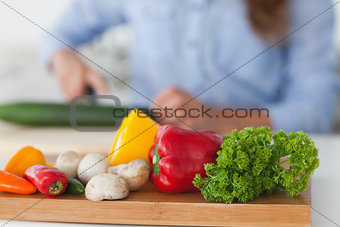 Wooden board with vegetables on a table
