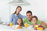 Portrait of cute family having breakfast