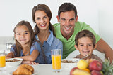 Portrait of parents having breakfast with their children