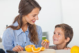 Little boy eating orange segments
