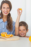 Little boy raising an orange segment