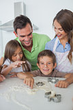 Brother with flour on the nose baking with his family